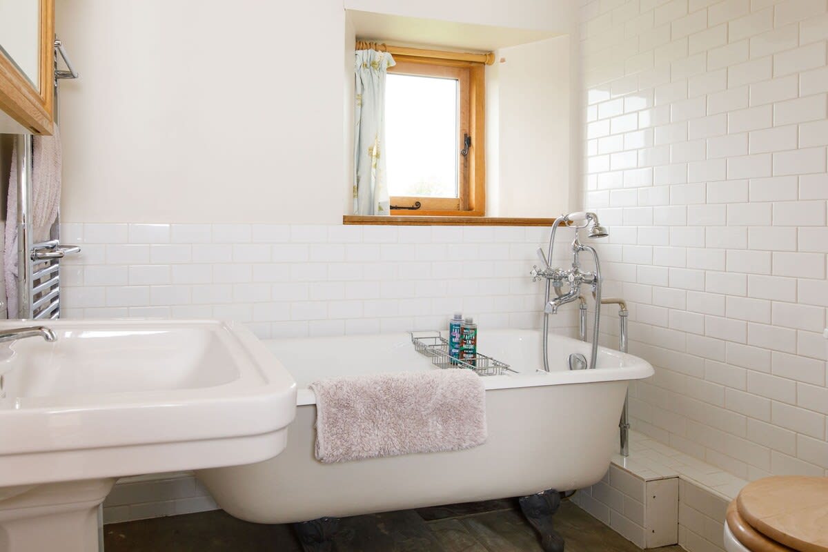 The ensuite has a bath, shower head, sink and WC.