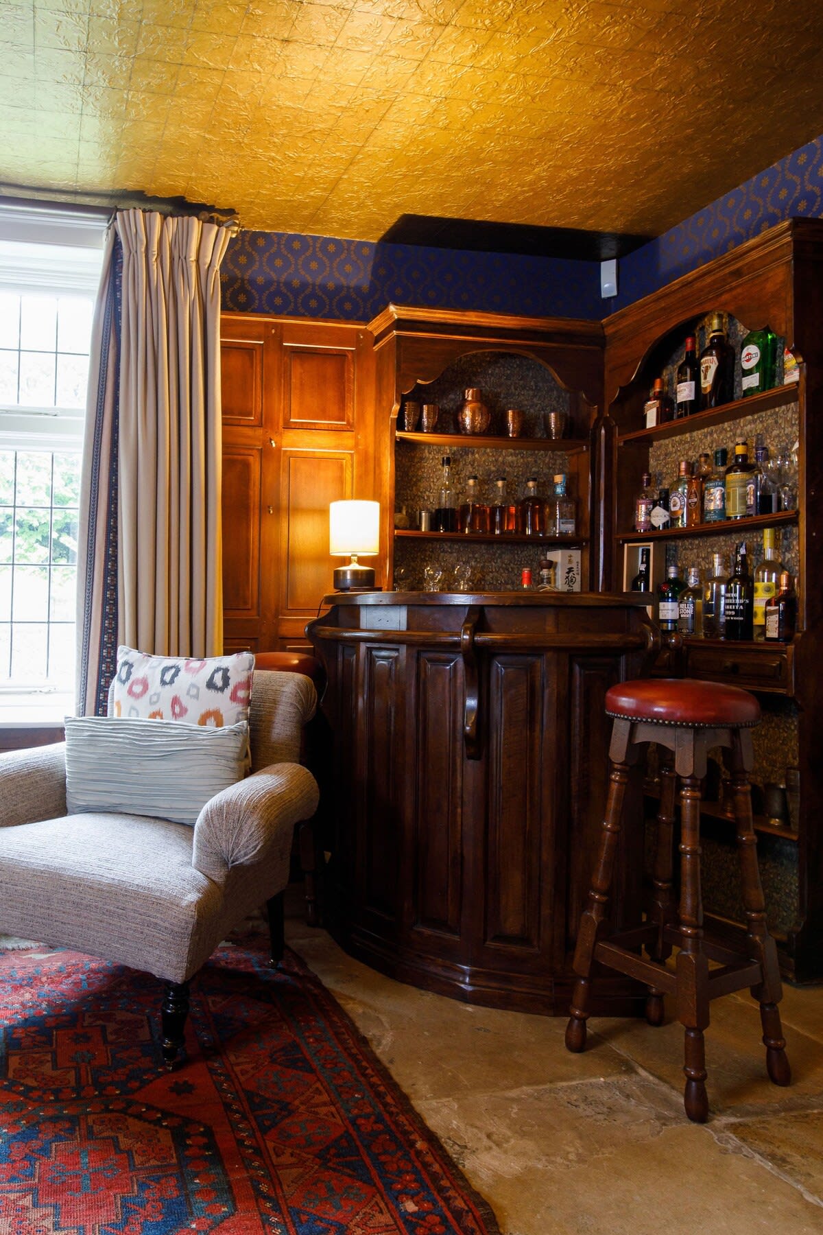 Pour a drink and relax by the study's bar.