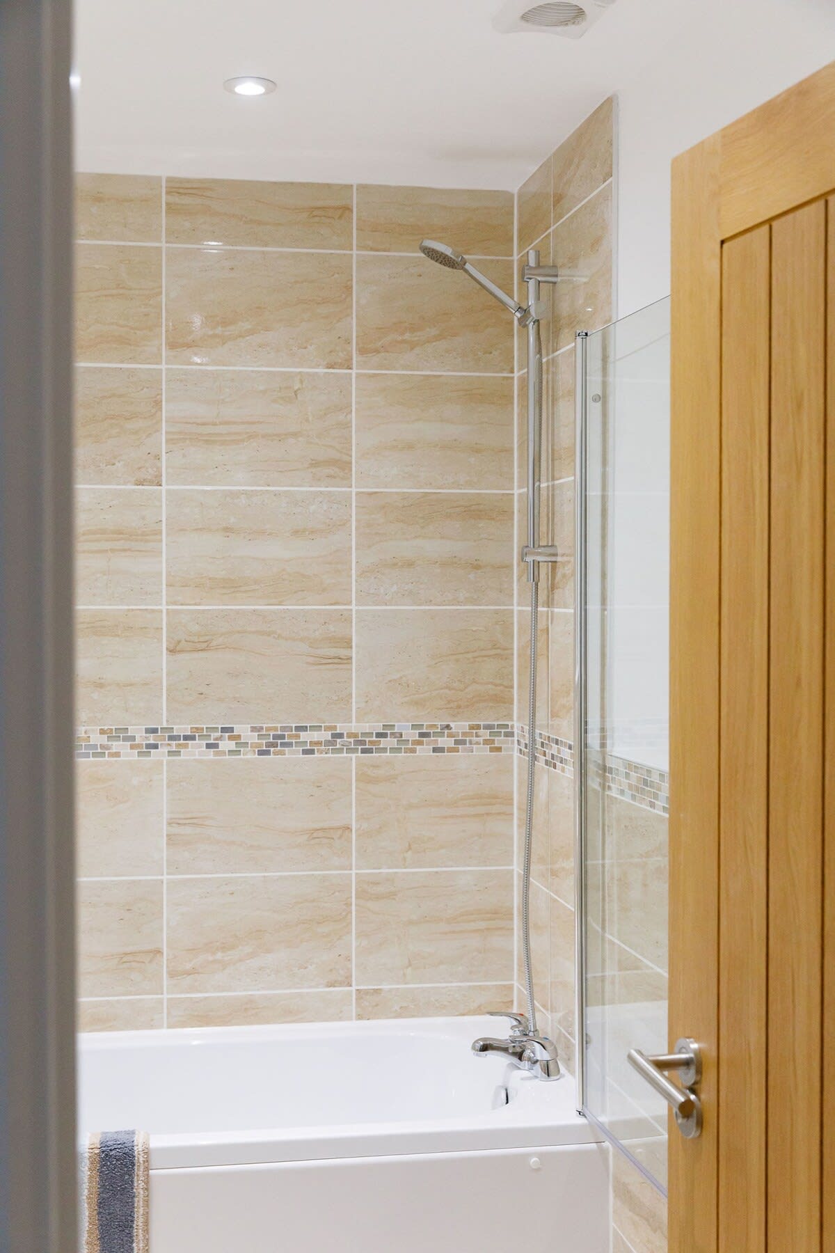 The family bathroom has an overhead shower.