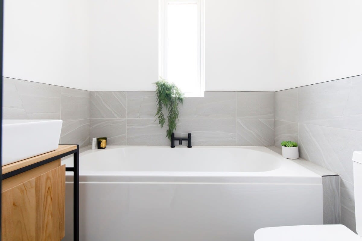 The family bathroom has a bath and overhead shower.