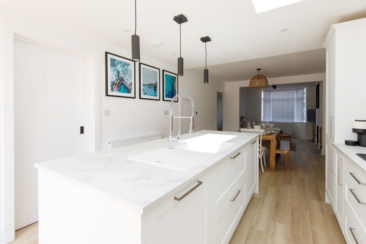 The open plan kitchen/diner has stunning white marble worktops.
