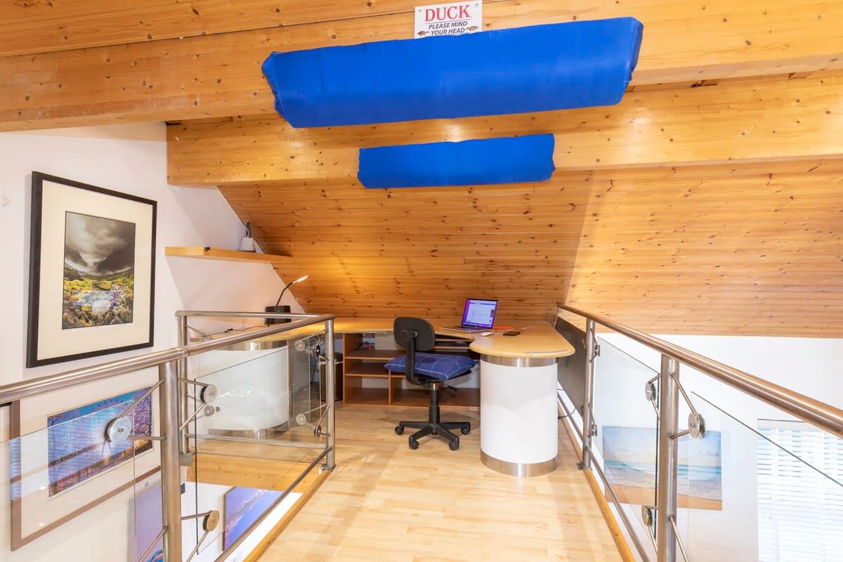 The landing morphs into a quiet study space, ideal for work or relaxation.