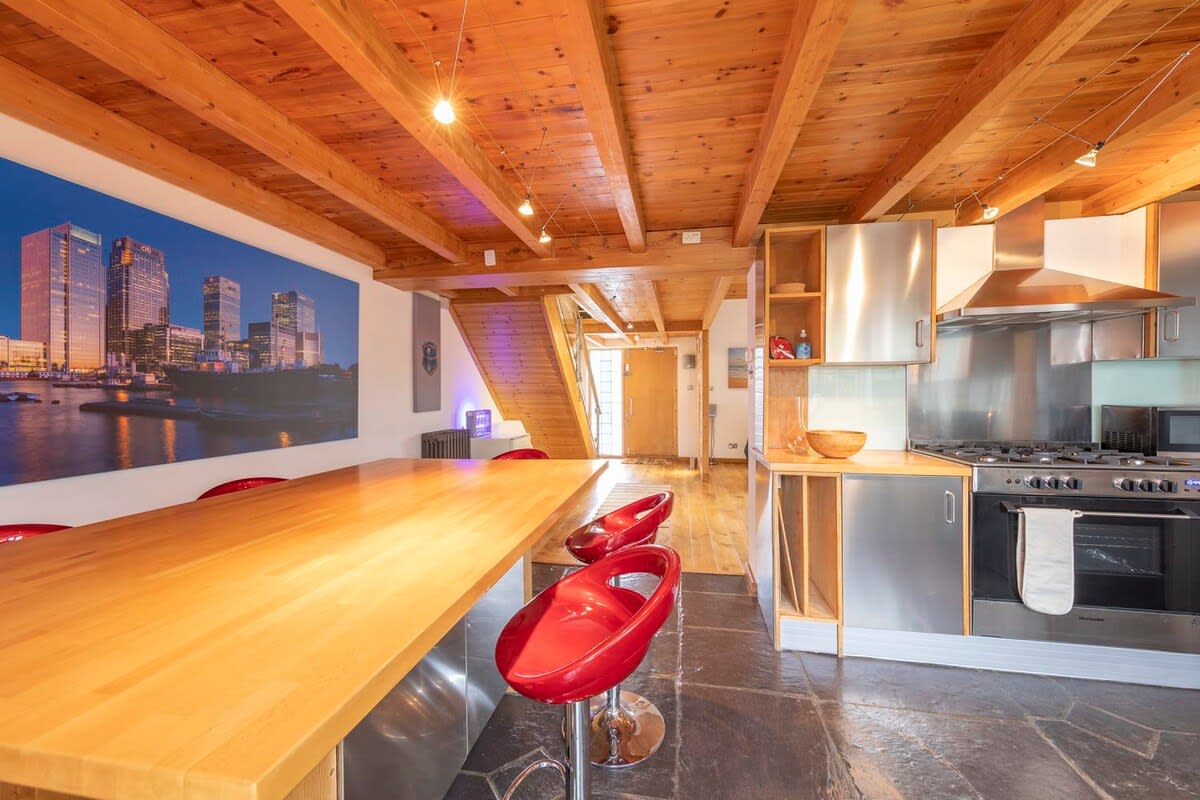 There is a sleek kitchen island with seating for four.