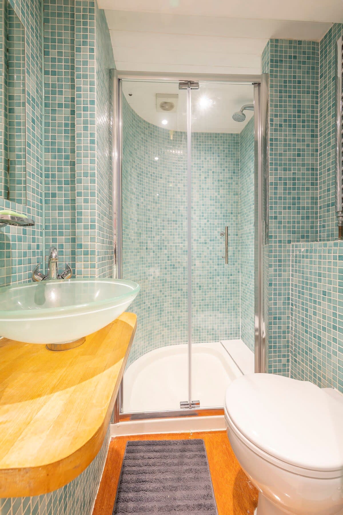 The en-suite is a modern walk-in shower complemented by a sink and toilet.