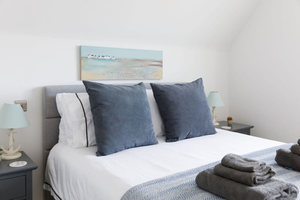 The master king bedroom has premium pillows, bedding and linen along with bedside tables with reading lamps.