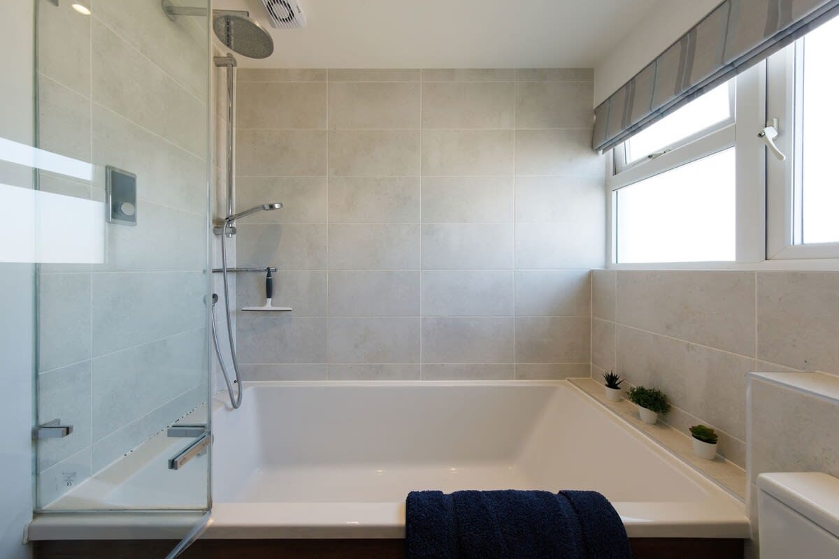 The bath has an overhead shower.