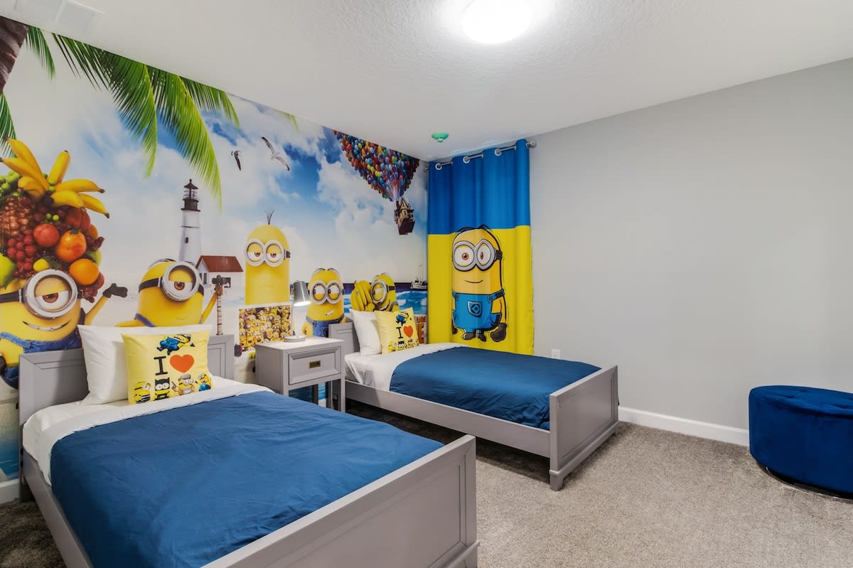 Delight in this fun-themed bedroom, perfect for kids, featuring vibrant decor and cozy twin beds for an unforgettable stay.