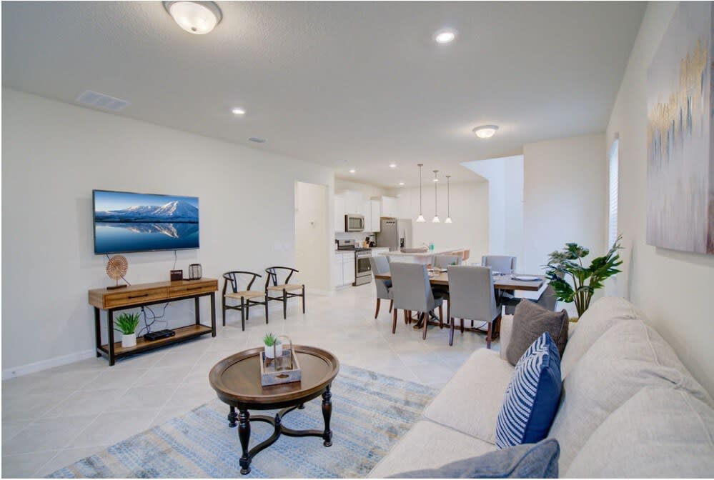 Spacious open-plan living and dining area with modern amenities and stylish decor, perfect for relaxation and entertaining.