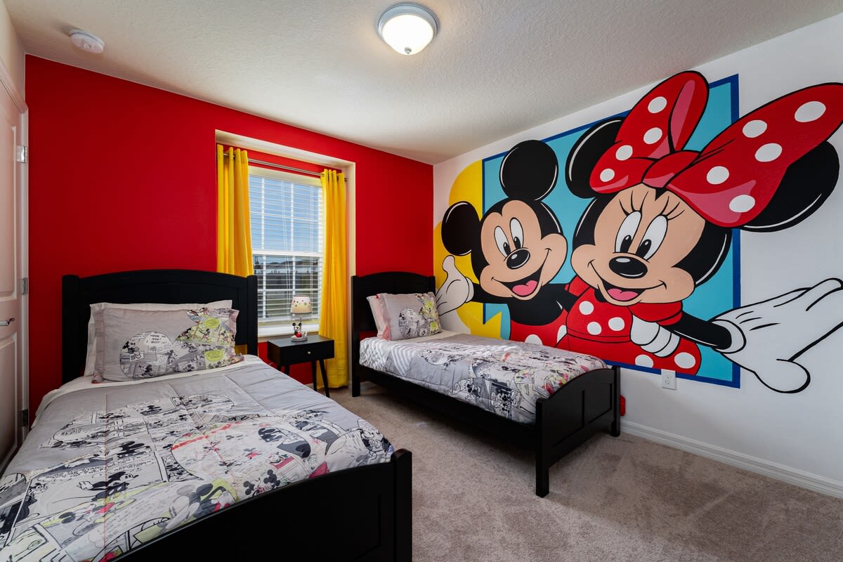 Enjoy a whimsical stay in this cartoon-themed bedroom with twin beds and a colorful mural, perfect for a family adventure!