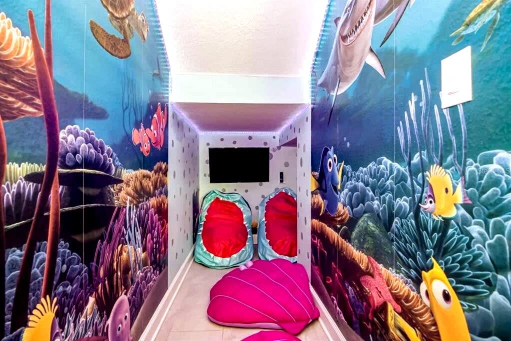 Dive into a vibrant ocean-themed room with colorful murals and cozy bean bags, perfect for sparking kids' imaginations.