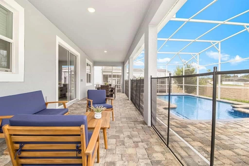 Relax on the chic patio with plush seating and serene pool views, perfect for sunbathing and unwinding in style.