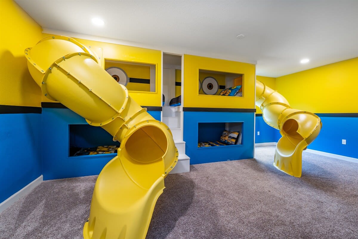Experience endless fun in this vibrant themed room with slides and cozy nooks, perfect for kids' adventures!