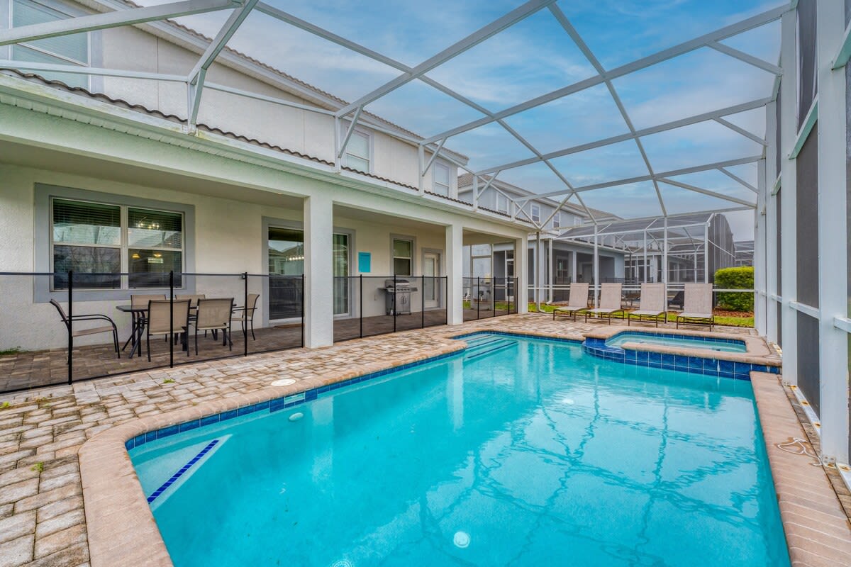 Enjoy your private screened pool with sun loungers and a dining area, perfect for relaxation and family gatherings.