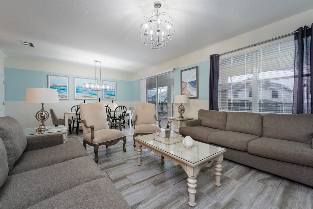 Spacious living room with plush seating and elegant decor, ideal for relaxation and gatherings.