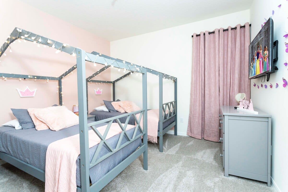 Charming princess-themed room with cozy canopy beds and enchanting decor, perfect for a magical stay.
