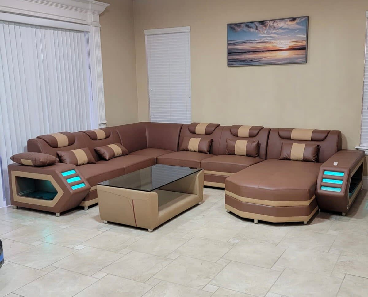 Relax in this stylish living room featuring a unique sectional sofa with LED accents, perfect for family gatherings or movie nights!