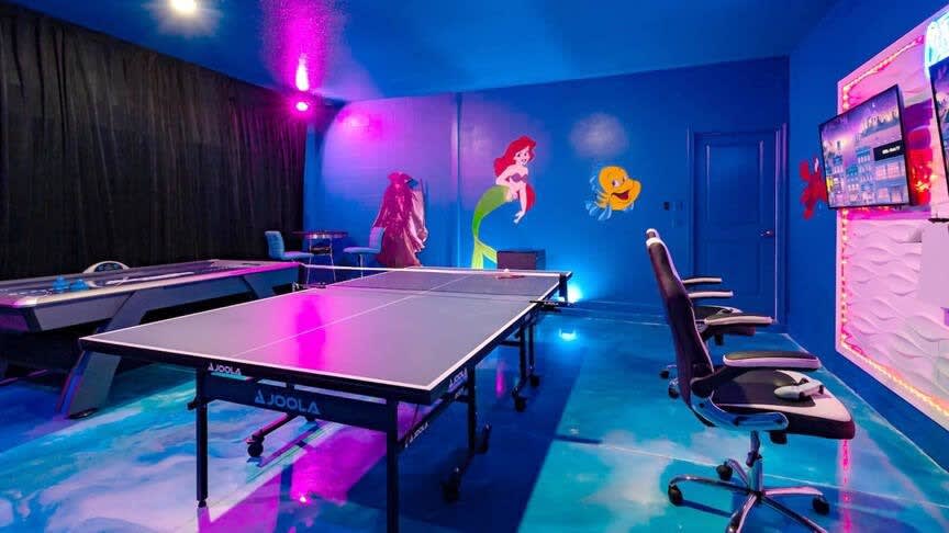 Dive into fun in this vibrant game room with ping pong, air hockey, and lively murals—perfect for family entertainment!