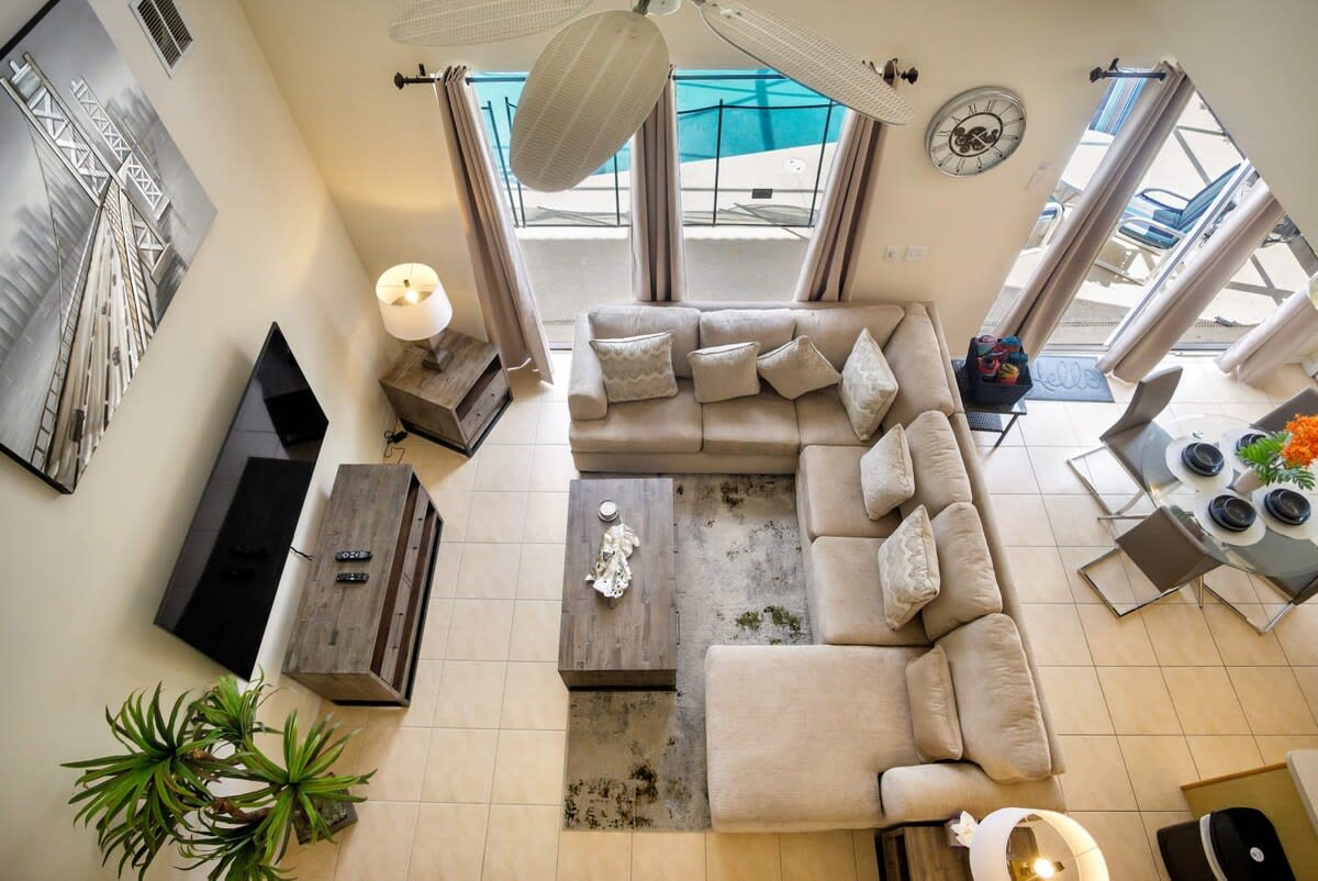 Relax in style with a plush L-shaped sofa and pool view, perfect for unwinding after a day of adventure.