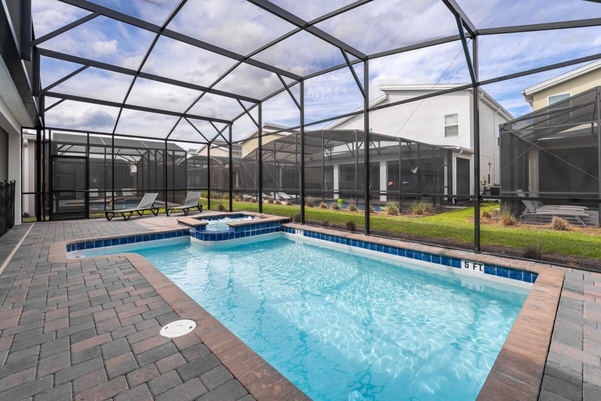 Dive into relaxation in your private screened pool and hot tub, perfect for unwinding or family fun.