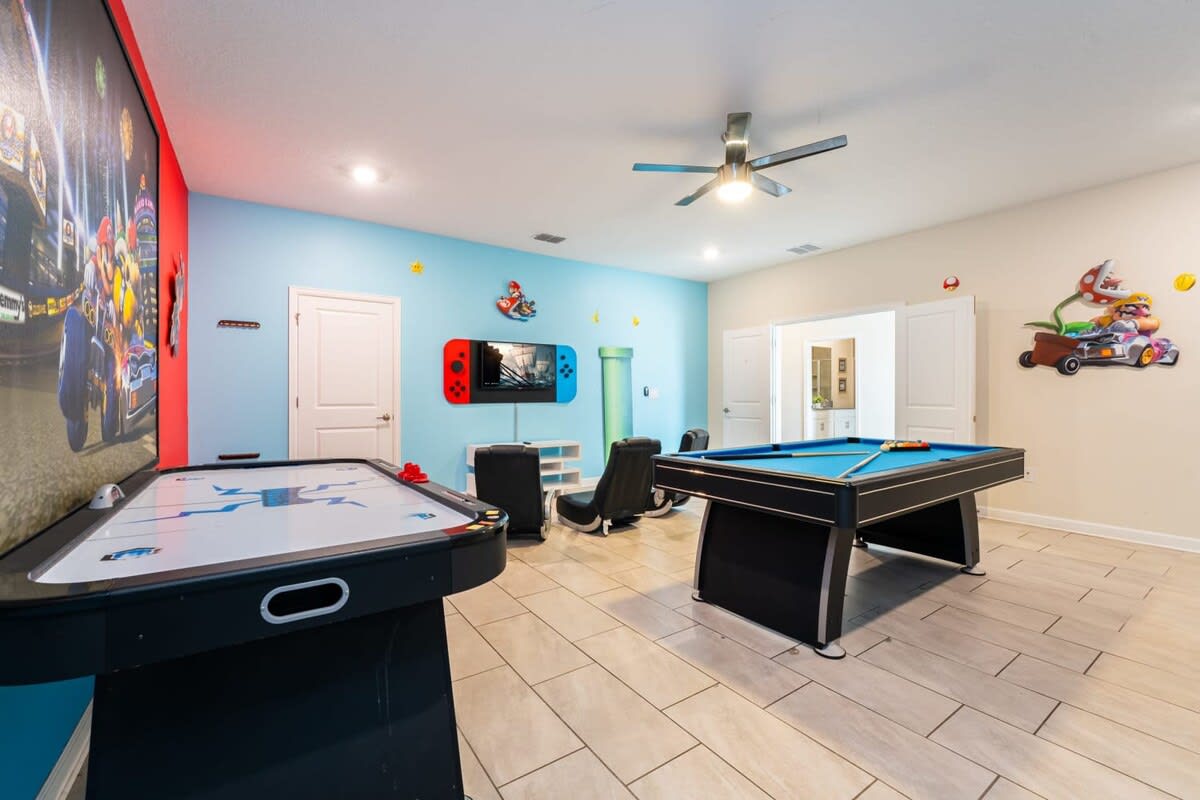 Experience endless fun in this vibrant game room with pool and air hockey tables, perfect for family entertainment!