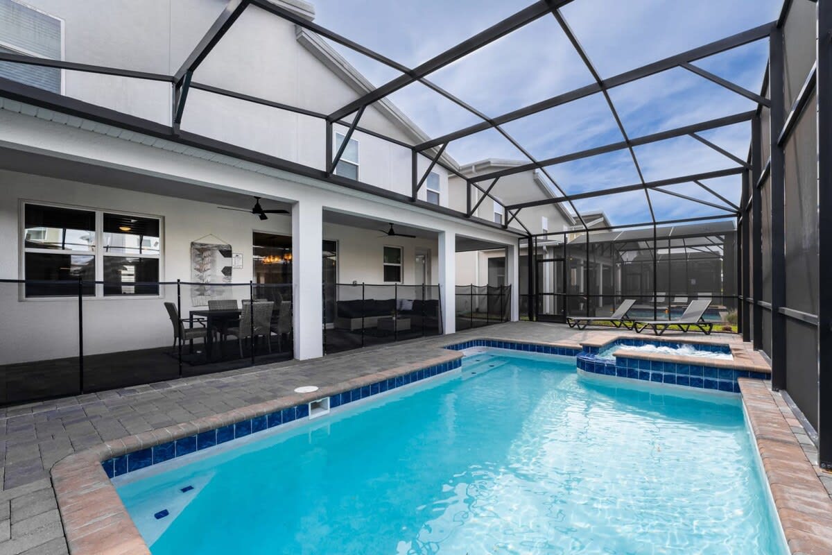 Enjoy a refreshing dip in your private screened pool and hot tub, perfect for relaxation and family fun.
