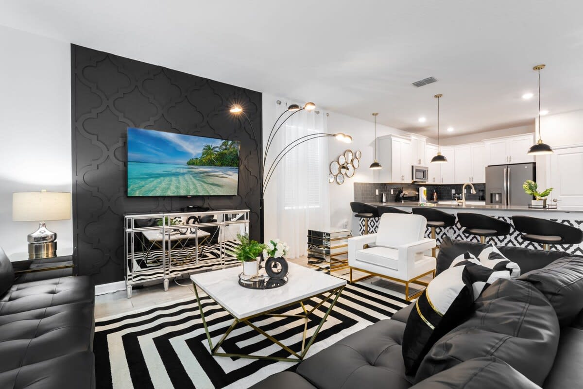 Stylish living area with modern decor and open kitchen, perfect for entertaining and relaxation.