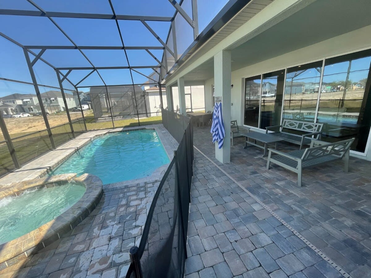 Enjoy your private screened pool and spa, ideal for family relaxation on the spacious patio.