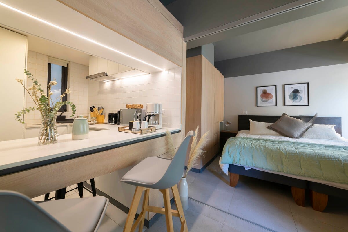 Cozy studio with modern kitchen and comfortable sleeping area, perfect for a relaxing stay in the heart of the city.