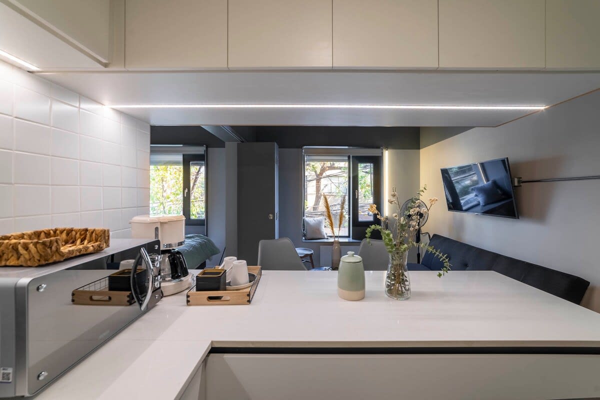 Sleek and modern kitchen with all essentials, offering a cozy and inviting atmosphere for your stay.