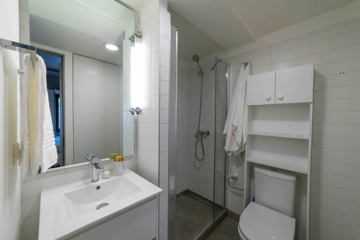 Modern and bright bathroom with sleek fixtures and ample storage, perfect for a refreshing start to your day.