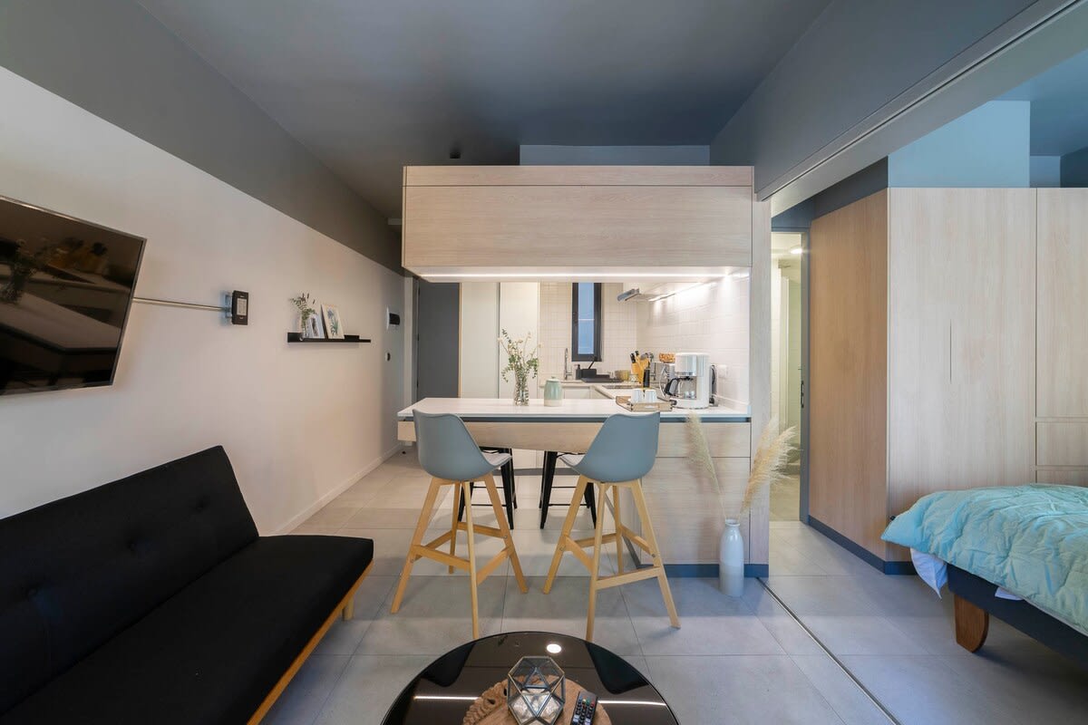 Experience modern living in this stylish studio with a sleek kitchen, cozy seating, and smart design.