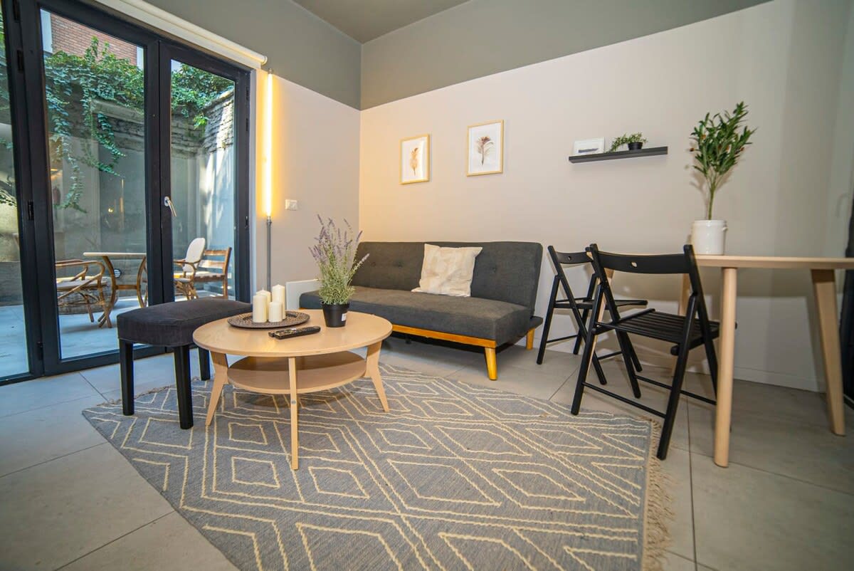 Cozy living area with patio access, perfect for relaxing or dining in style.