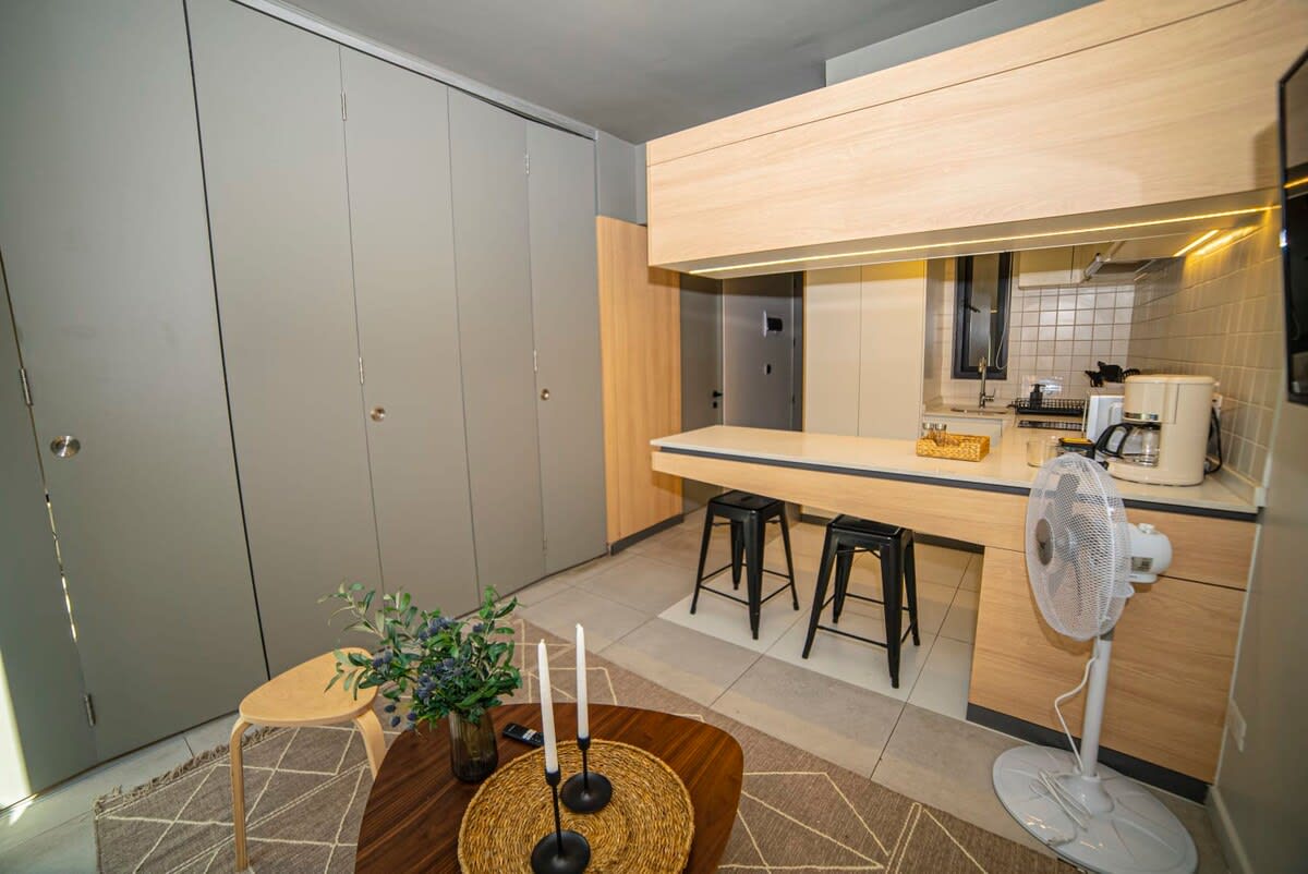 Cozy kitchen area with modern amenities and stylish decor, perfect for a comfortable stay.