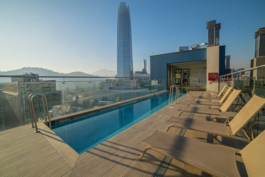Enjoy breathtaking city and mountain views from this stunning rooftop pool oasis.
