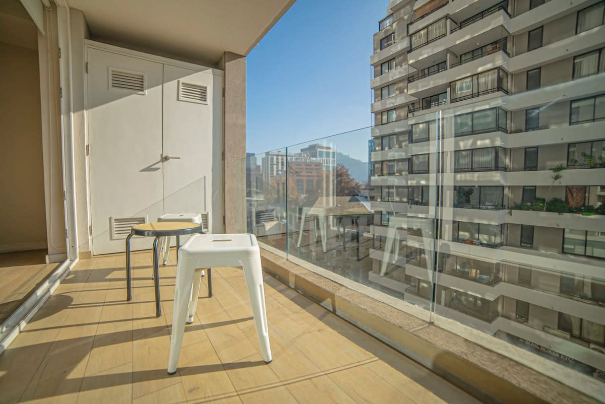 Enjoy your morning coffee with a stunning city view from this cozy balcony.