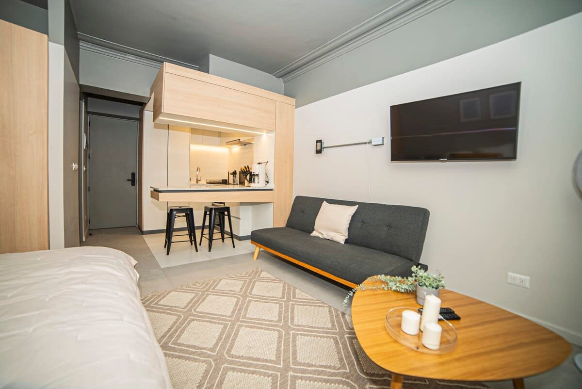 Chic studio with modern amenities, cozy seating, and a stylish kitchen—perfect for a comfortable city escape.