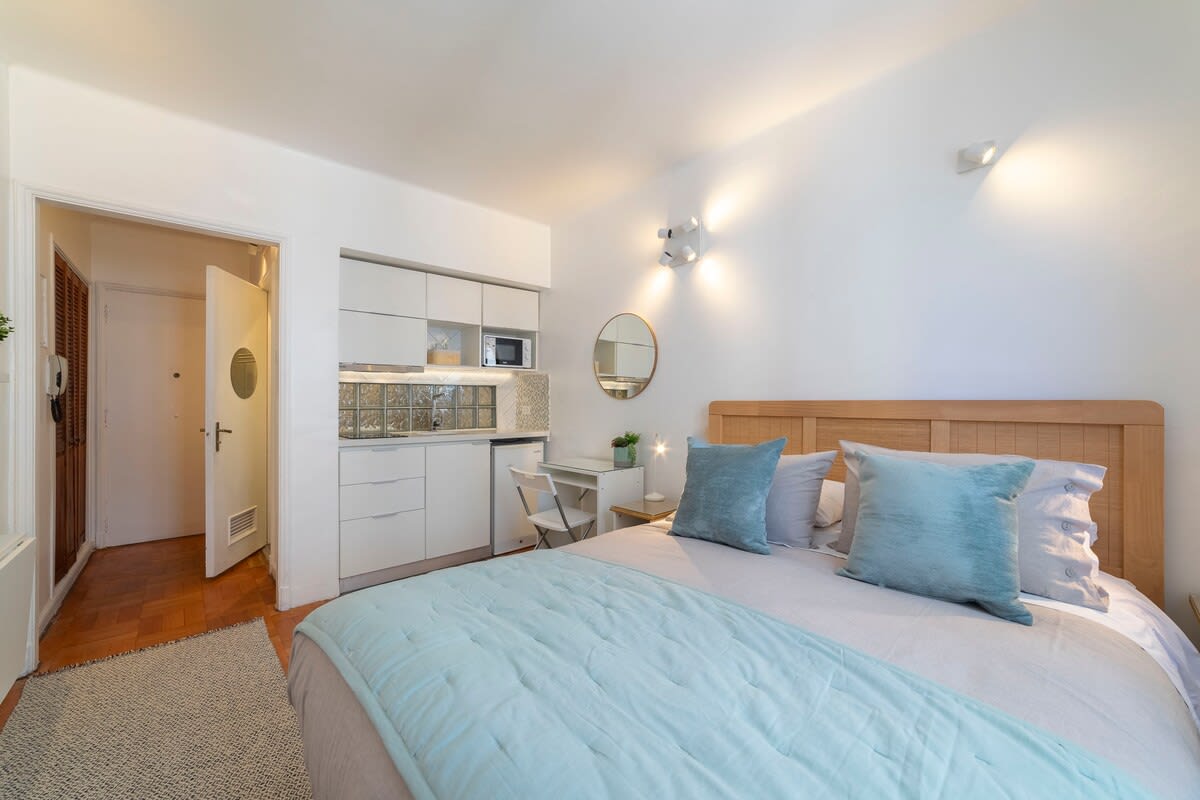 Cozy studio with a comfortable bed, modern kitchenette, and workspace—perfect for a relaxing stay in the heart of the city.