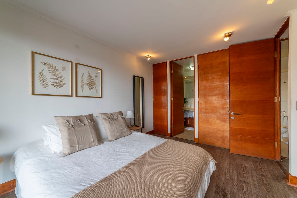 Cozy bedroom with elegant decor and natural light, perfect for a restful stay.