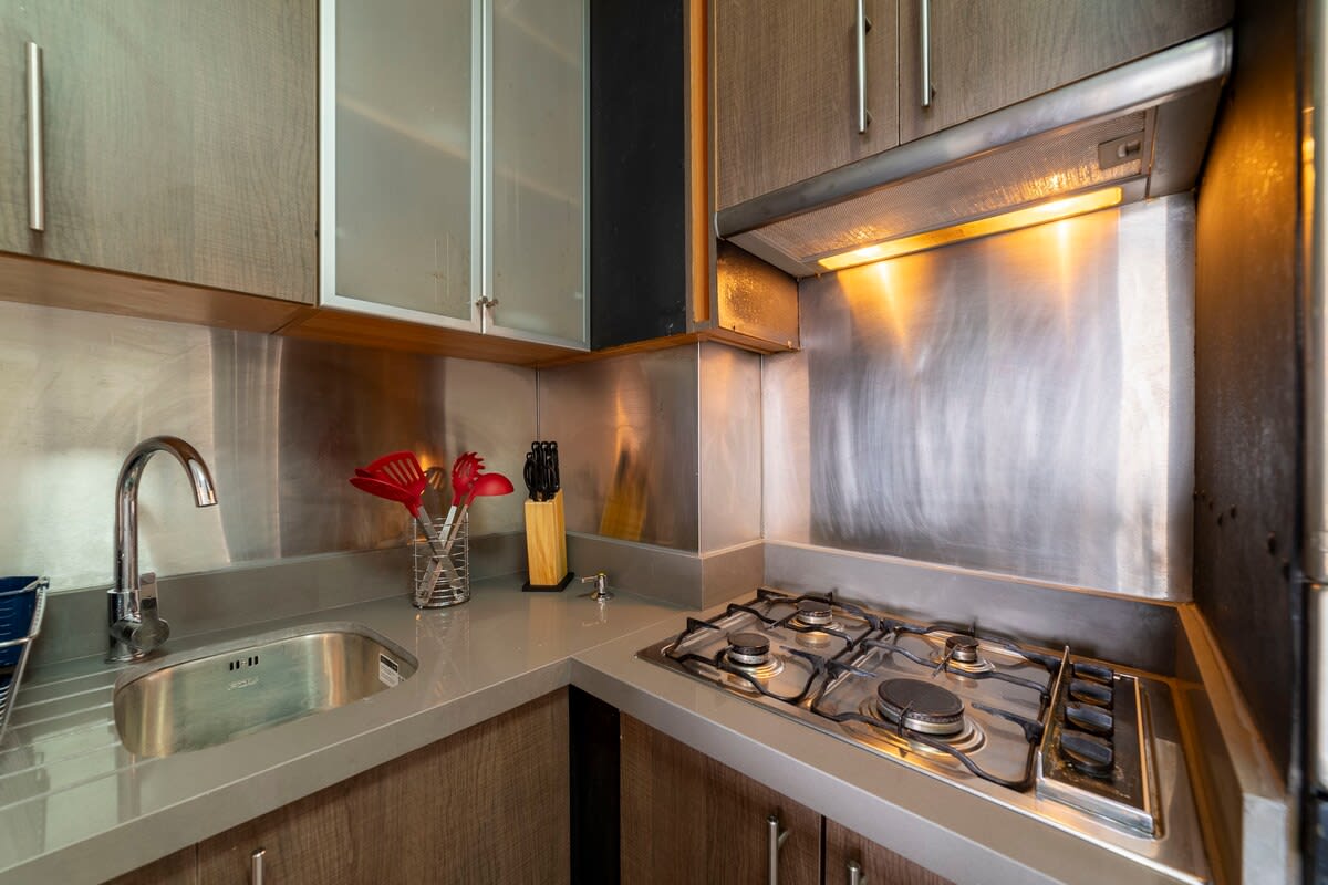 Modern and efficient kitchen with sleek stainless steel finishes, perfect for preparing meals during your stay.