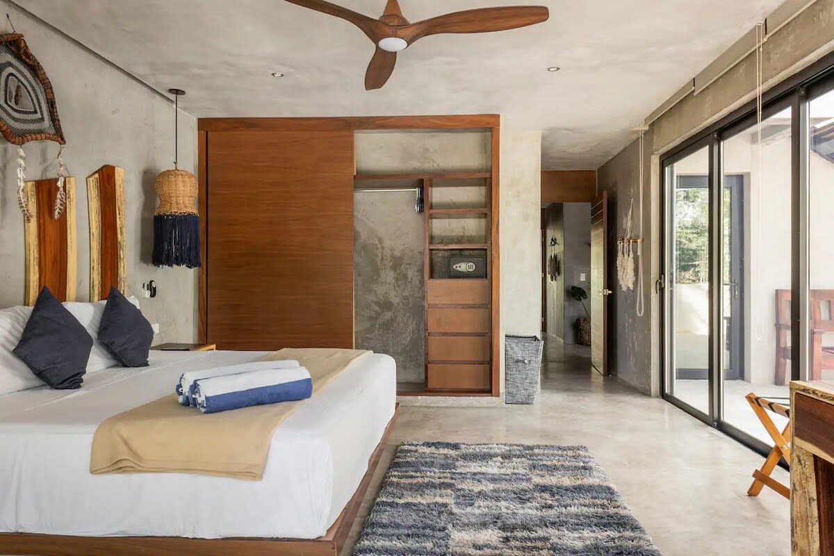 Second floor bedroom 4, featuring king bed, ensuite bathroom, private balcony and direct access to shared patio area