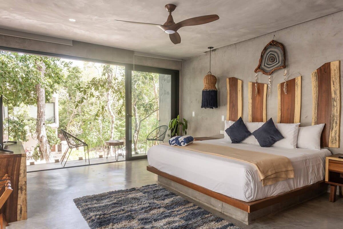 Bedroom 4, featuring king bed with private balcony access and ensuite bathroom
