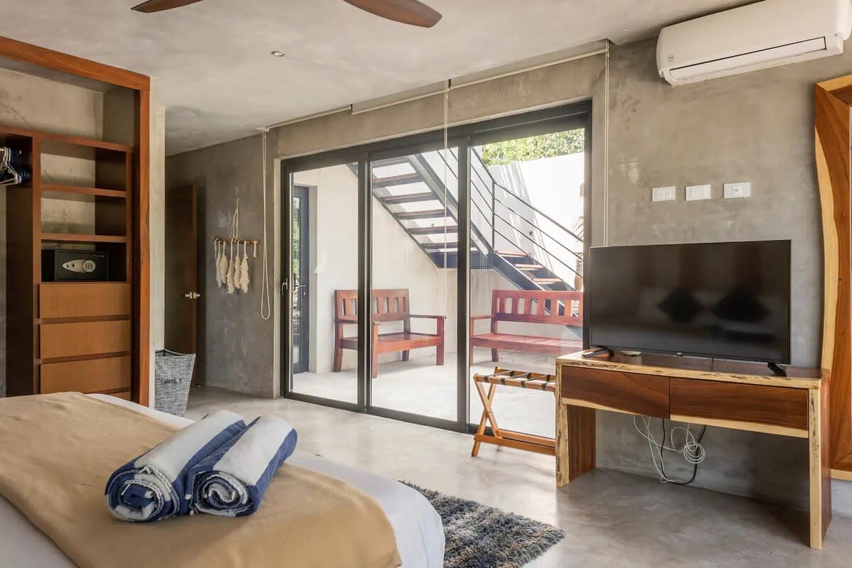 Bedroom 3, featuring private balcony and direct access to middle floor shared patio