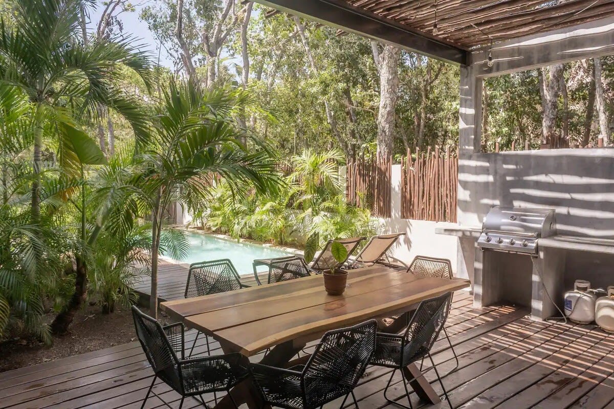 Private garden area with outdoor dining and BBQ