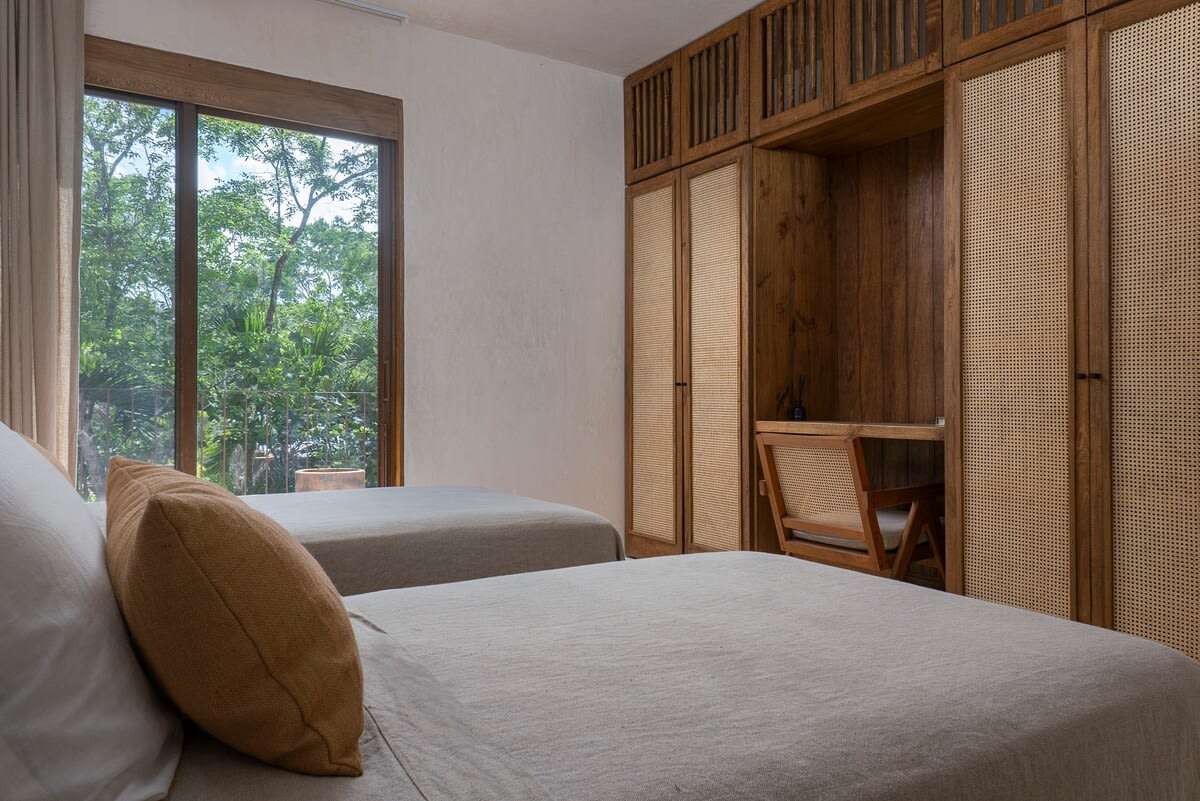 Bedroom with two beds and workspace.