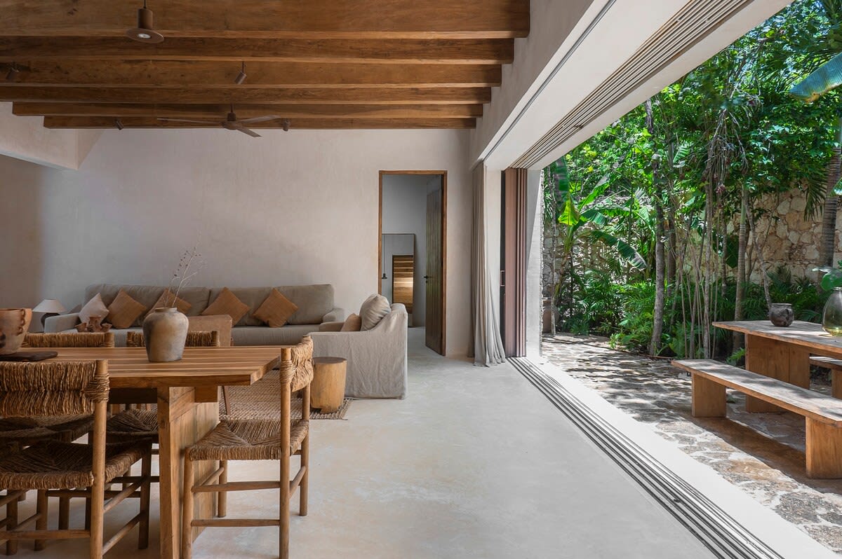 Open-concept ground floor, where the living-dining area is located, with access to the private patio. A bedroom is located at the back.