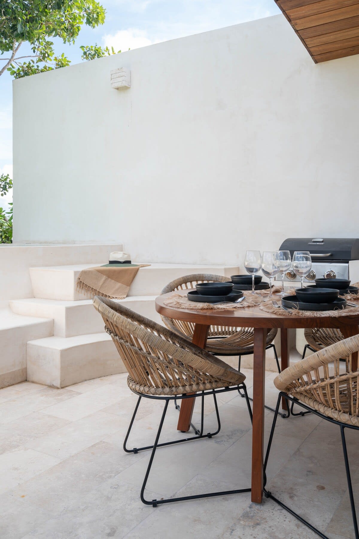 Outdoor patio with a dining area, grill, and plunge pool.