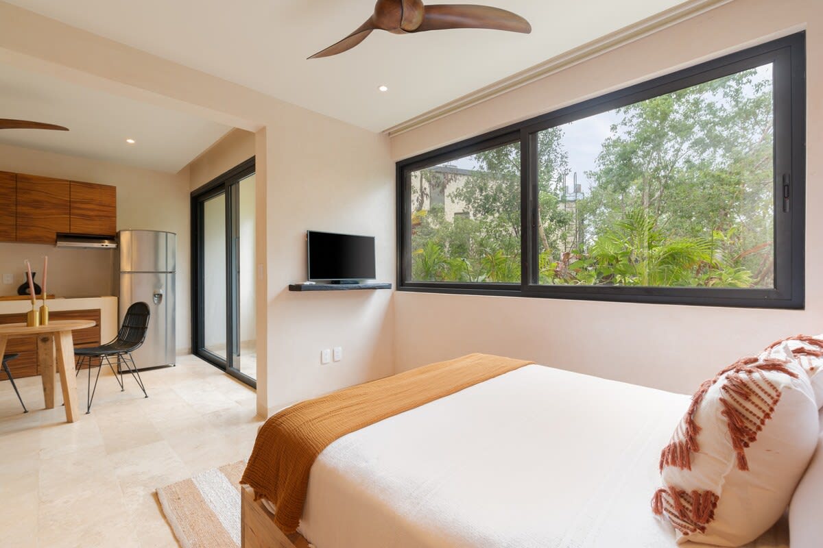 Bedroom #2, with ensuite kitchen, dining area, sofa, smart tv