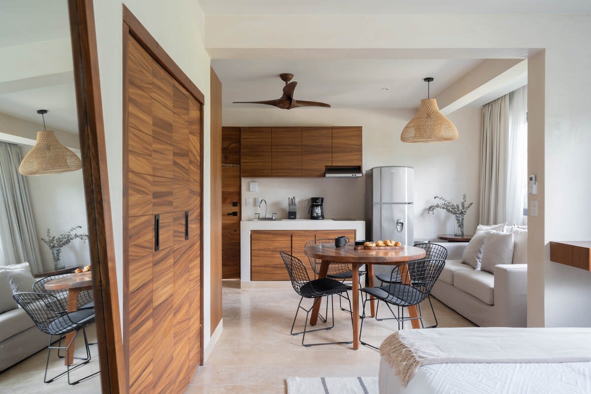 Bedroom with dining area and kitchen.