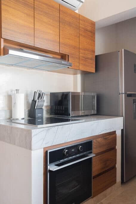 Living room with kitchen and access to rooftop terrace