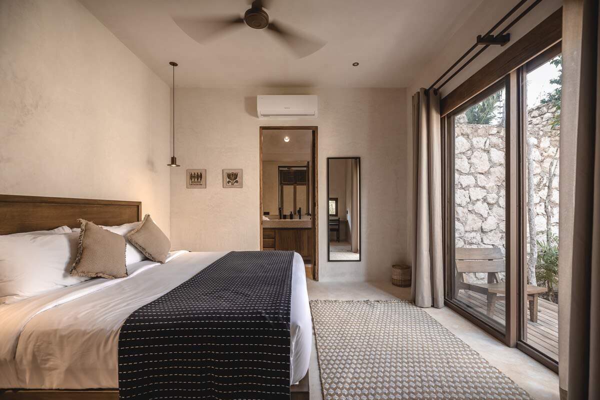 Main floor bedroom, with ensuite bathroom, dedicated workspace and private outdoor access